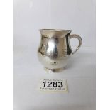 A silver Christening mug,