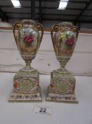 A pair of 19th century Austrian floral urns on stands