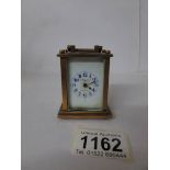 A miniature brass carriage clock marked Mignon,