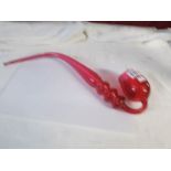 A cranberry glass pipe