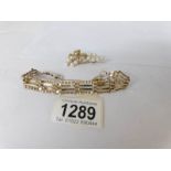 A 9ct gold gate bracelet and a gold brooch set pearls