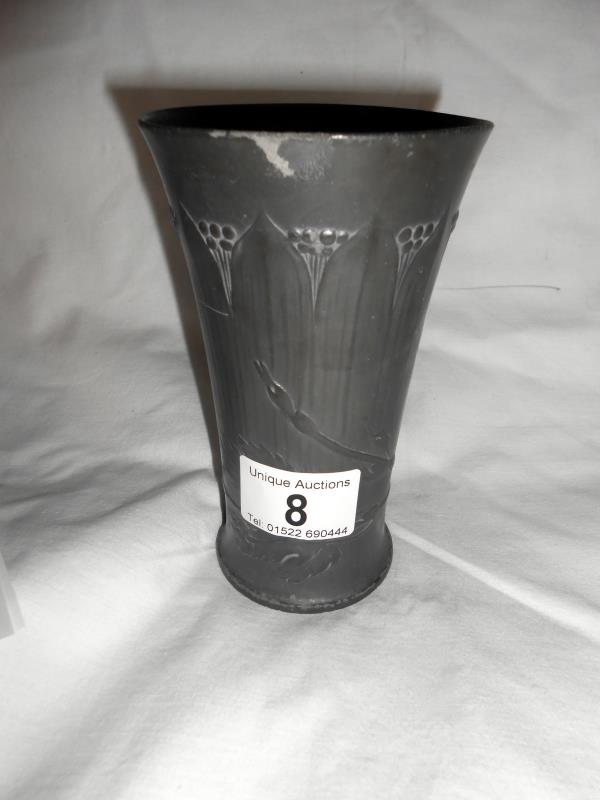 An art nouveau pewter vase