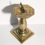 A miniature brass table sundial