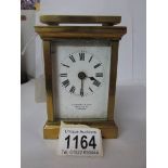 A brass carriage clock marked E Lenton & Son, 169, High Street,
