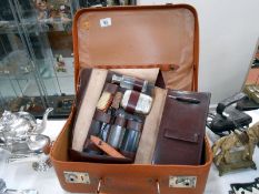 A gentleman's travelling vanity case and a small retro suitcase