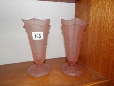 A pair of pink glass vases