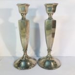 A pair of silver candlesticks, 19.