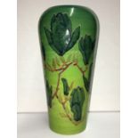A Dennis china works vase decorated with magnilias