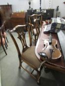 A mahogany extending dining table and 4 chairs