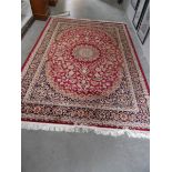 A red ground Keshan carpet,