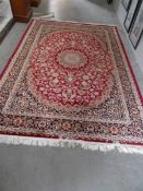 A red ground Keshan carpet,