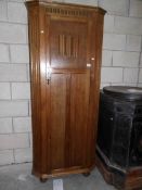 An oak Priory style hall cupboard