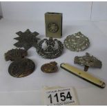 A quantity of military badges etc