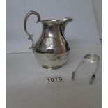 A Hall marked silver jug together with hall marked silver sugar tongs