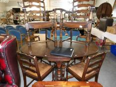An oak gate leg dining table and a set of 6 dining chairs