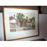 A framed and glazed watercolour village scene