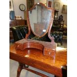 A shield shaped mahogany toilet mirror