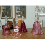 3 cranberry glass bells and a ruby glass bell