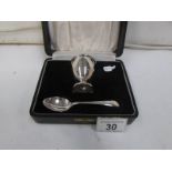 A cased silver egg cup and spoon