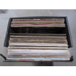 A box of LP records including The Clash, Genesis,