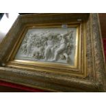 A gilt framed marble plaque with cherub scene and medallion to rear