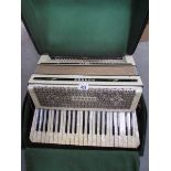 An old Hohner Tango III piano accordion in case