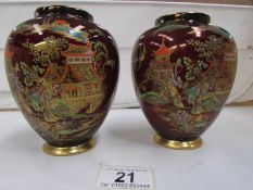 A pair of Carlton ware rouge royale vases (missing lids,