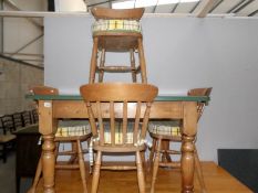 A pine table and 4 chairs