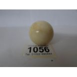 A small solid ivory snooker cue ball