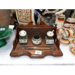 An oak inkstand with ceramic ink well and nib cleaner
