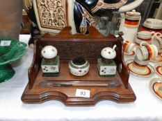 An oak inkstand with ceramic ink well and nib cleaner