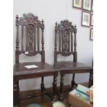 A pair of Gothic style hall chairs