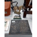 A cast iron sign, doorstop, flat iron,