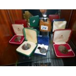 A quantity of commemorative coins and a hip flask