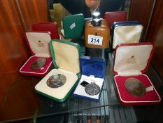 A quantity of commemorative coins and a hip flask