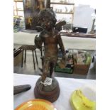 A bronze figure of a cherub