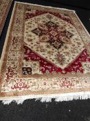 A beige ground Heriz carpet,