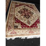 A beige ground Heriz carpet,