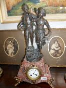 A French marble and gilt clock surmounted pair of figures