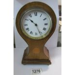 A mahogany inlaid Edwardian balloon clock,