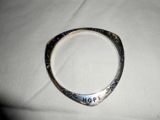 A silver bracelet inscribed Hope,