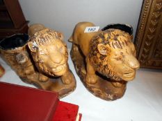 A pair of art deco plaster lion planters