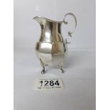 A silver cream jug,