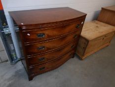 A mahogany bow front 4 drawer chest on splay feet