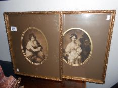 A pair of framed and glazed oval prints