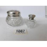 2 silver topped vanity bottles