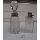 A silver rimmed scent bottle and one other