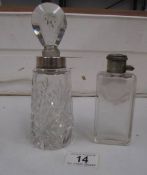 A silver rimmed scent bottle and one other
