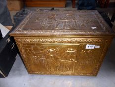 A brass log bin