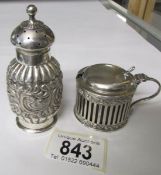 A silver pepper pot and a silver mustard pot